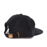 Black corduroy cap with a gold buckle on a white background