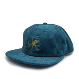 Blue corduroy cap with a blue ringed octopus design on a white background