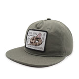 Green cap with a snake patch on a white background