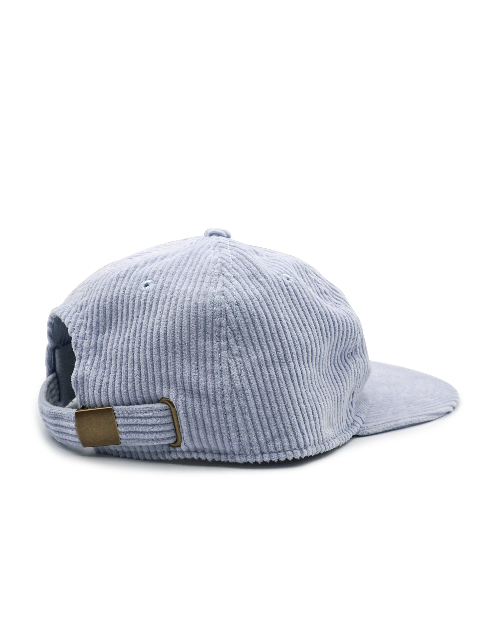Blue corduroy cap with a brown patch on a white background
