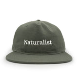 Earth green cap with 'Naturalist' text on a white background