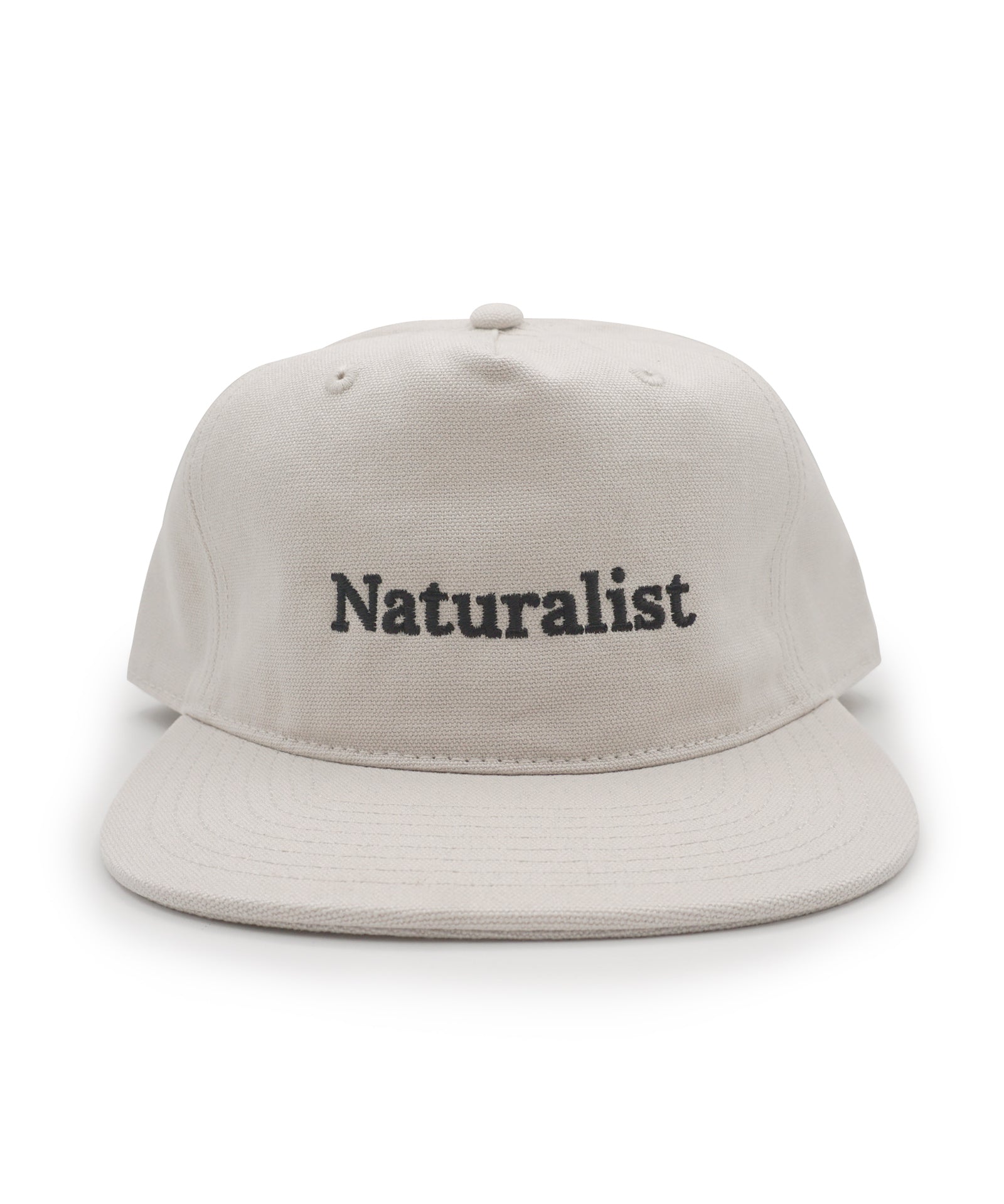 Bone colored cap with 'Naturalist' text on a white background