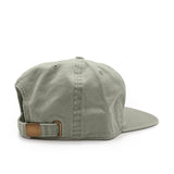Leaf green cap with a brown strap on a white background