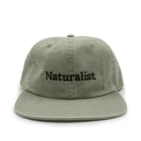 Leaf green cap with 'Naturalist' text on a white background
