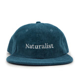 Teal corduroy cap with 'Naturalist' embroidery on a white background