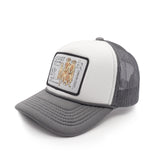 Gray and white youth trucker hat with a meerkat patch on a white background
