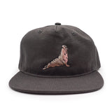 Black cap with an embroidered elephant seal design on a white background