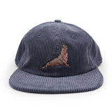 Blue corduroy cap with an embroidered elephant seal design on a white background