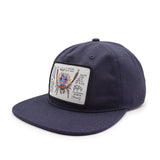 side view of a Navy blue cap with a peacock spider patch on a white background