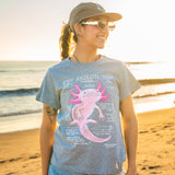 Person wearing a t-shirt with an axolotl graphic on a beach