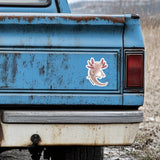 Rustic blue truck with a pink and white axolotl sticker on the back