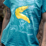 Person wearing a teal t-shirt with a yellow Pacific Banana Slug graphic and text.