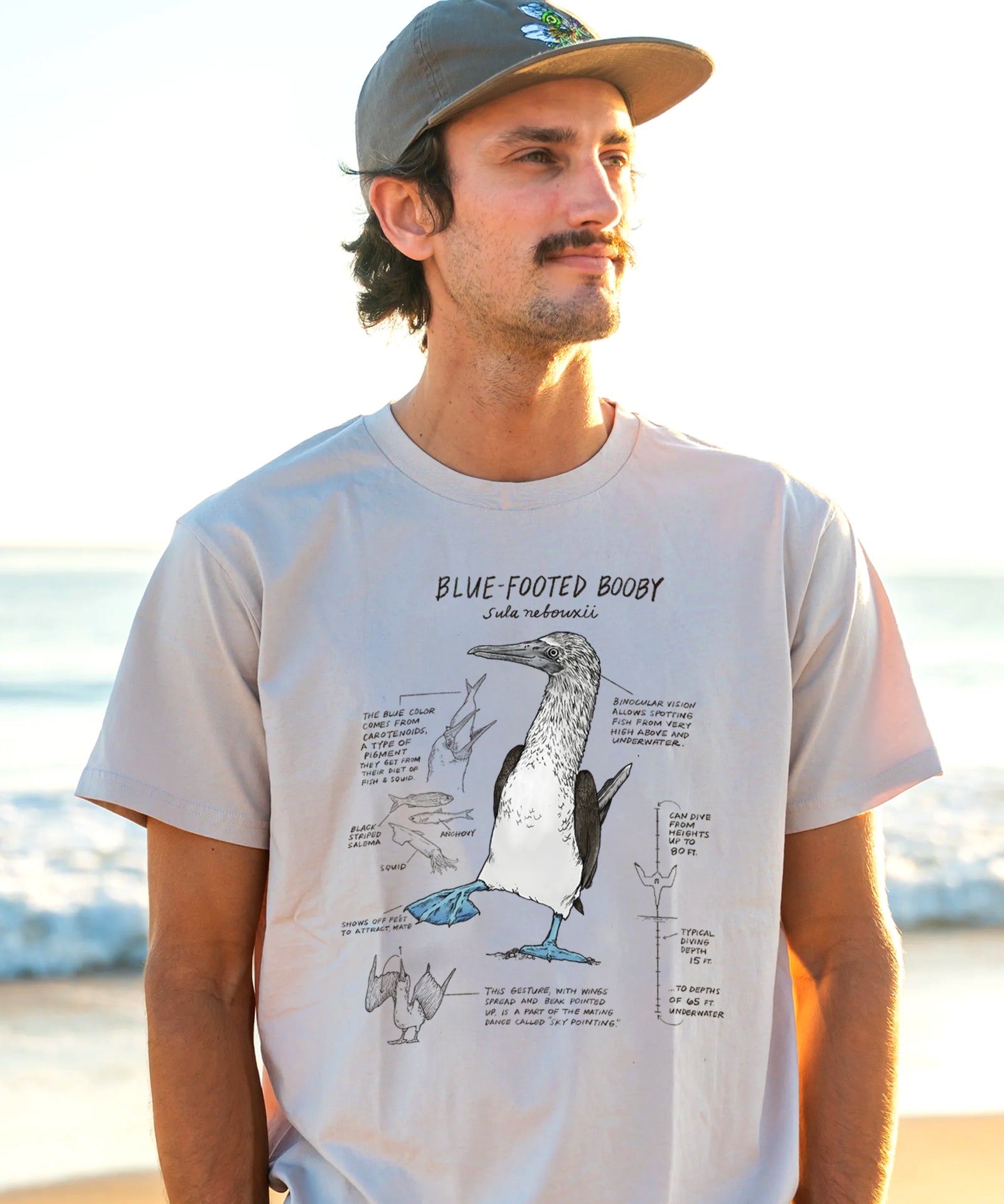 man wearing a t-shirt with an illustration of a lue-footed booby