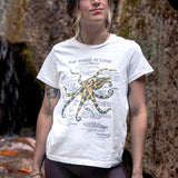 Woman wearing a white t-shirt with an octopus design outdoors.