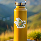 Yellow water bottle with a sticker of a praying mantis on a rock with a mountainous background
