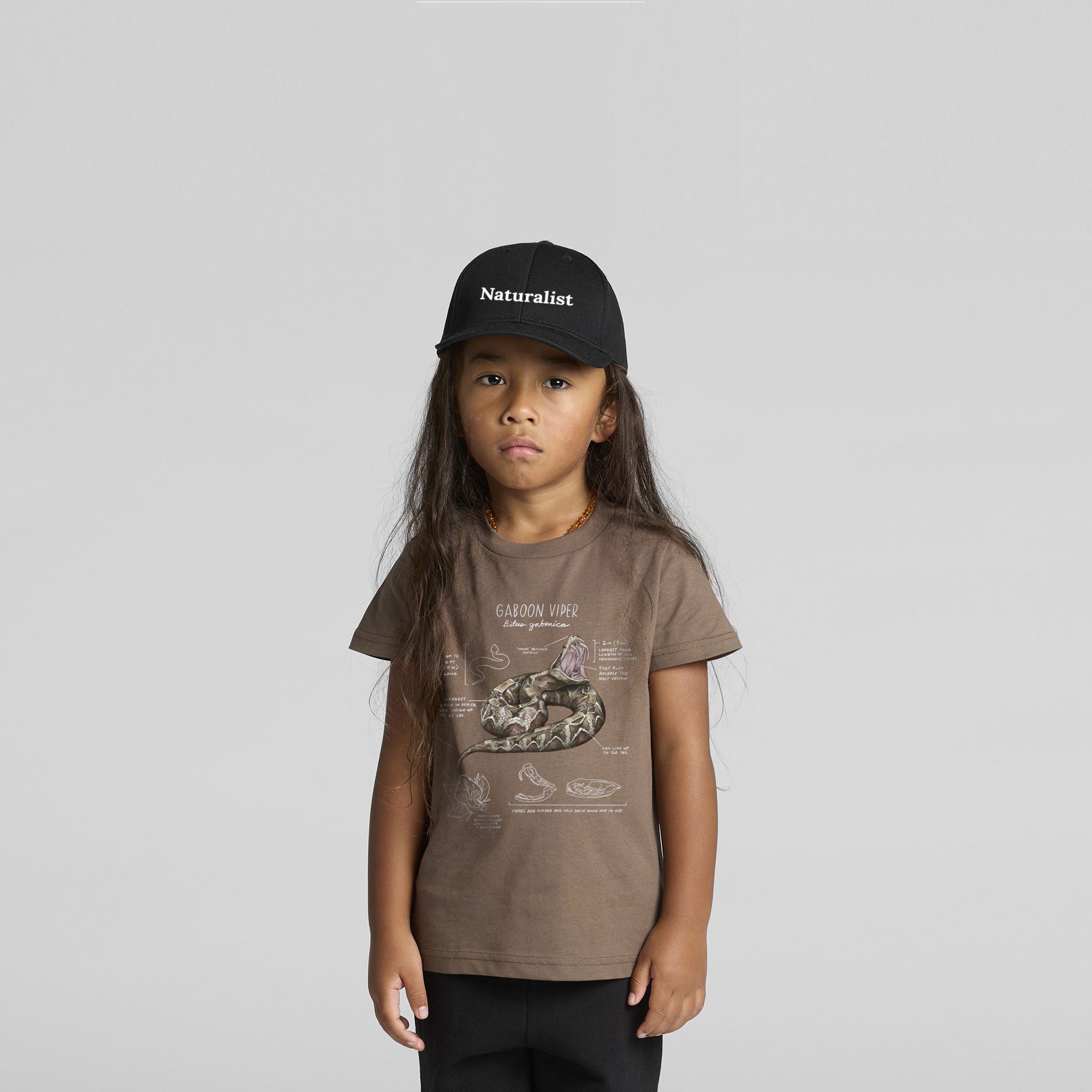 child wearing a brown tee with a goboon viper printed on it and a naturalist hat
