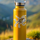 Yellow water bottle with a  blue ringed octopus design on a rock with a mountainous background