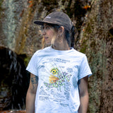 Person wearing a white t-shirt with a spiny flower mantis illustration 